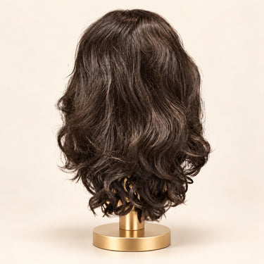 Back view of the dark brunette synthetic sample wig with soft waves and loose curls.