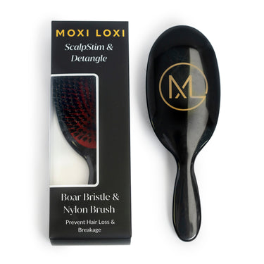 ScalpStim and Detangle Brush by Moxi Loxi, stimulating the scalp while gently detangling wigs and natural hair.