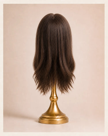 Back view of The Motion archive wig in Cool Truffle showing the finished shape, layered movement, and 16 inch length.