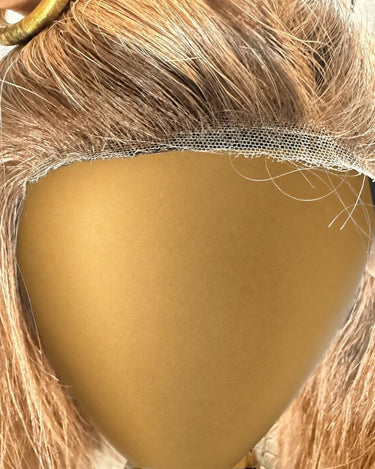 Cappuccino Motion archive wig hairline and lace detail on a smooth gold display stand