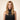 ELENA Silk Veil human hair wig shown on a model in Amber Bronde, a rooted golden blonde shade at 20-inch length.