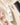 Moxi Loxi Foundation Mist 4 fl oz with an ivory towel and black wide-tooth comb in a salon-care flat lay
