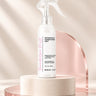 Moxi Loxi Foundation Mist 4 fl oz leave-in detangler and conditioner spray on an ivory studio pedestal