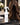 Moxi Loxi Foundation Mist 4 fl oz beside a brunette human-hair topper on a salon care stand