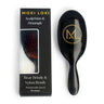 ScalpStim and Detangle Brush by Moxi Loxi, stimulating the scalp while gently detangling wigs and natural hair.