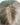 Close view of the crown and part on The Motion archive wig in Cool Truffle.