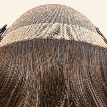 Close-up of the VELA welded nylon base edge and European human hair